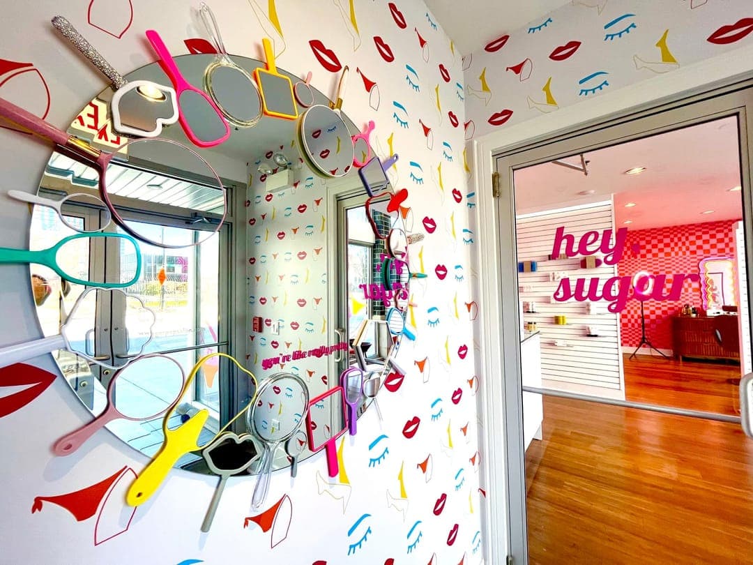 The mirror wall and lips wallpaper inside Sugar Pop Salon